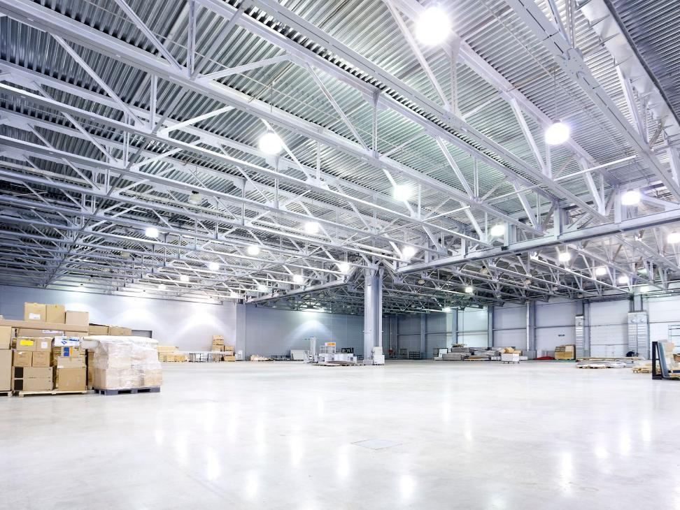 High-bay lighting installed across the ceiling of a commercial warehouse