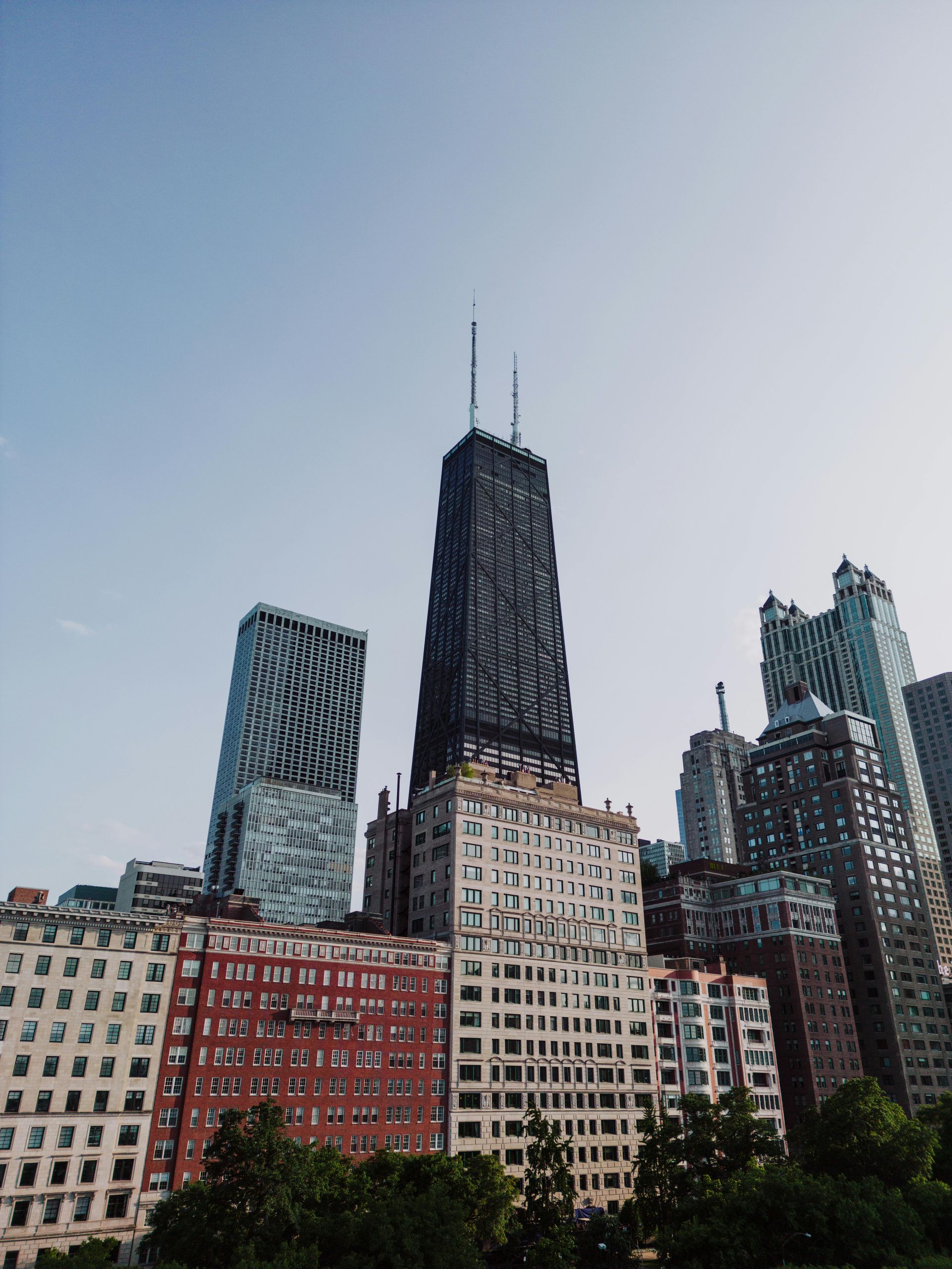 City skyline with tall modern skyscrapers under a pale sky