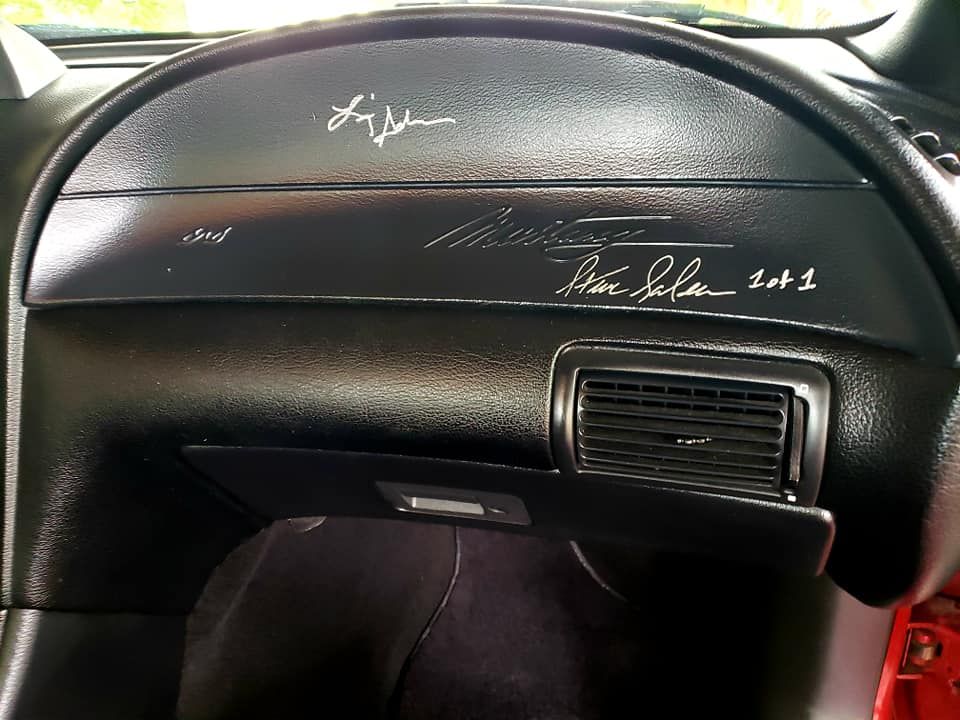 Black car dashboard with signatures and 