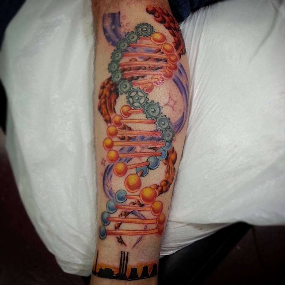 Colorful DNA helix tattoo on a forearm, with orange, blue, and green molecular details