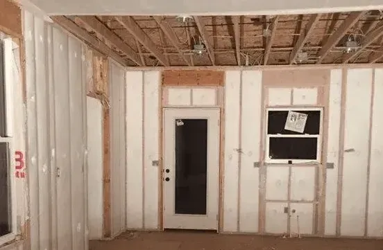 A room with a door and a window in it.