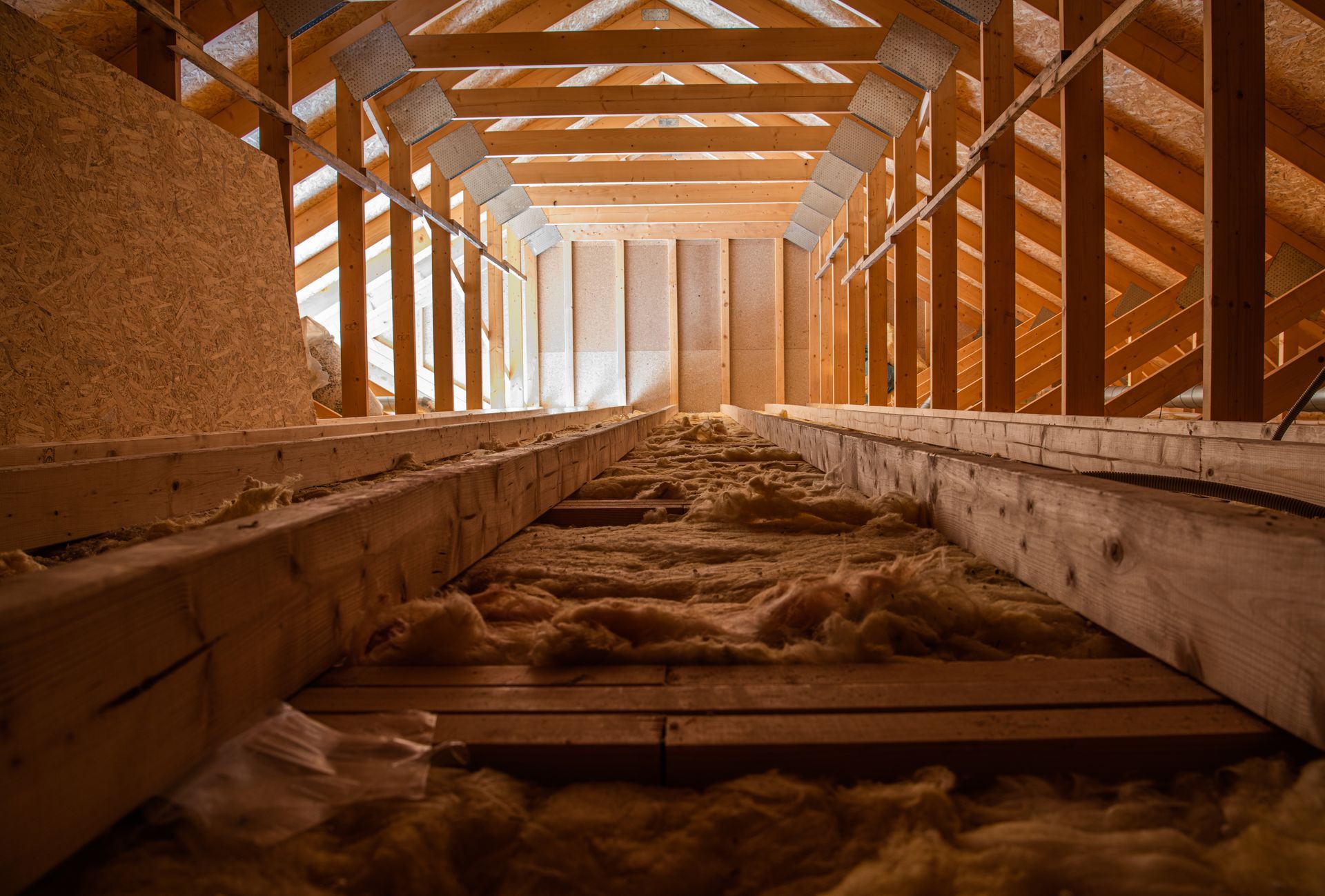Wood-framed industrial tunnel with flowing grain or sand moving along a central channel