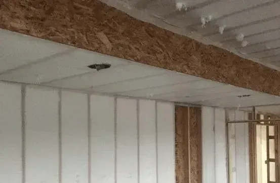A room with white walls and a wooden ceiling.