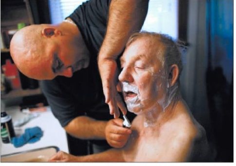 Jim trimming his father's beard