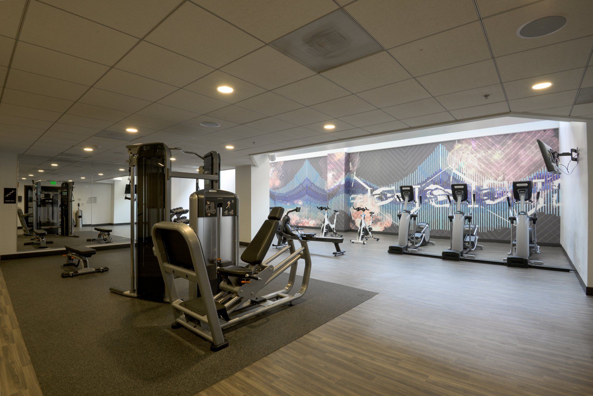 A large gym with a mural on the wall