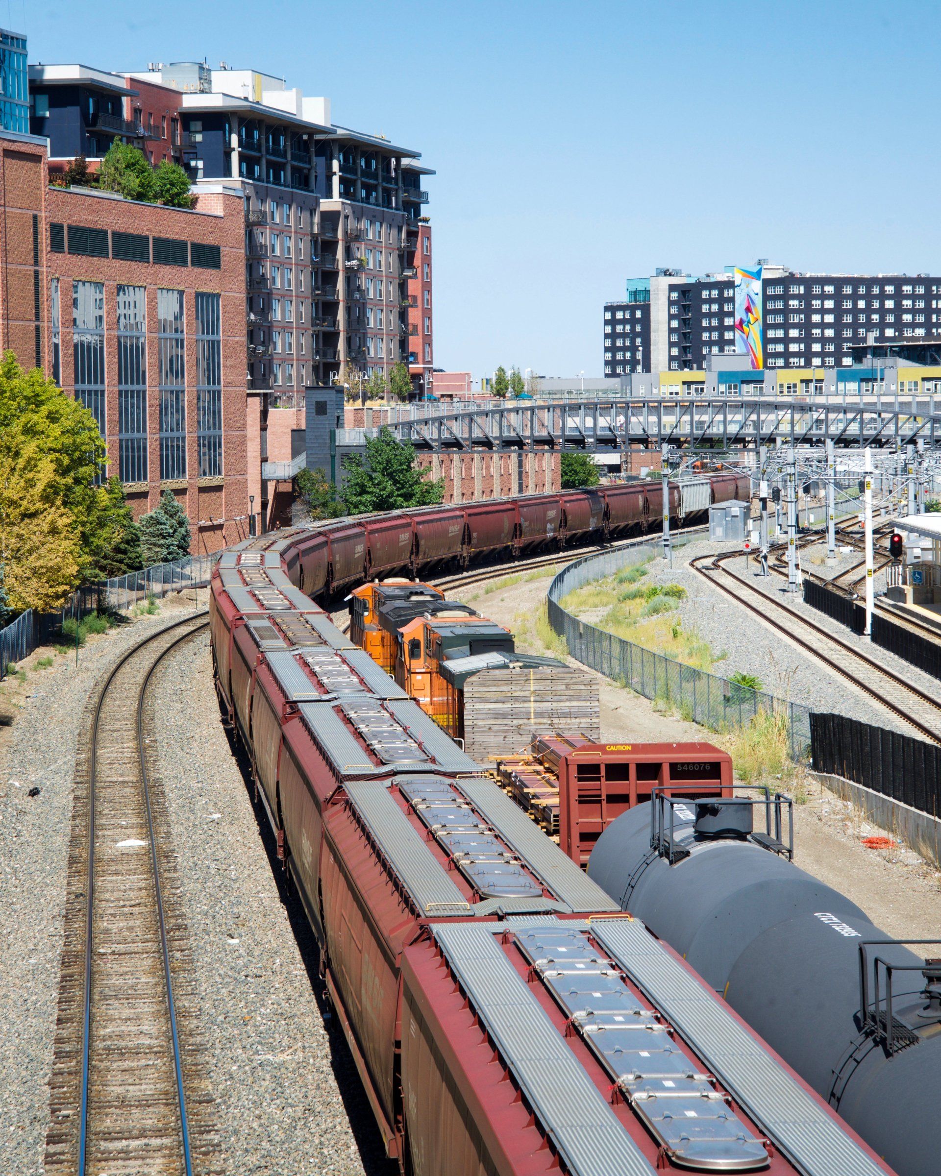 A train is going down the tracks in a city