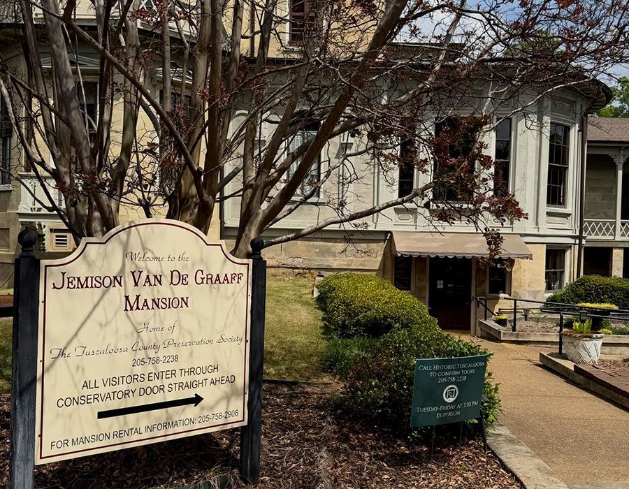 Jemison Van de Graaff Mansion sign beside a historic white house and garden path