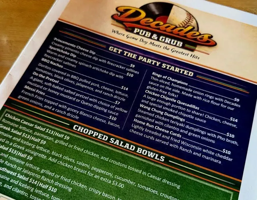 Restaurant catering menu for DeDe’s Pub & Grill with party platters and chopped salad bowls in black, blue, and orange print