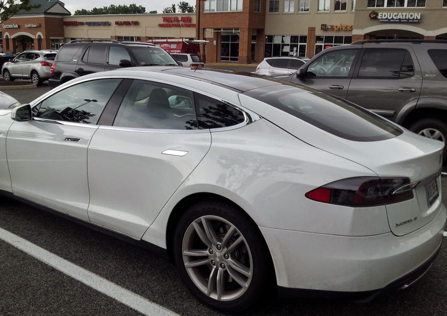 White Tesla sedan parked in a lot | Crown Car Care