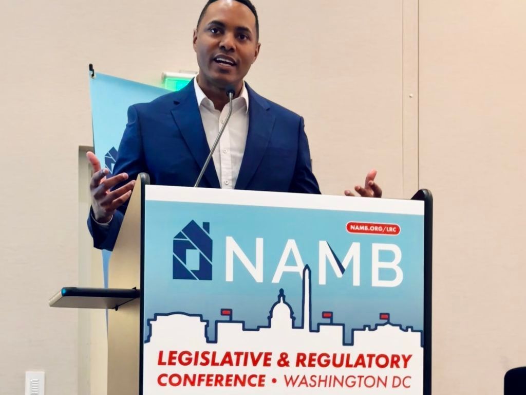 Speaker at podium with NAMB sign at legislative and regulatory conference