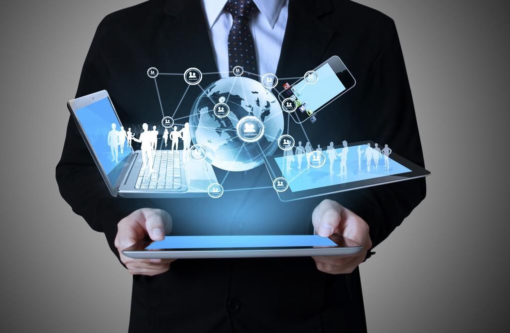 Businessman holding a digital tablet with glowing technology icons and virtual network graphics