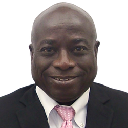 Portrait of a smiling man in a black suit with a pink tie on a white background