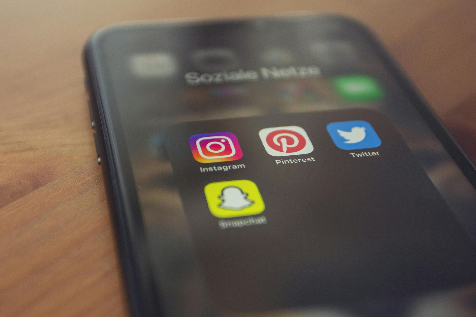 Smartphone screen showing social media app icons: Instagram, Pinterest, Twitter, and Snapchat.
