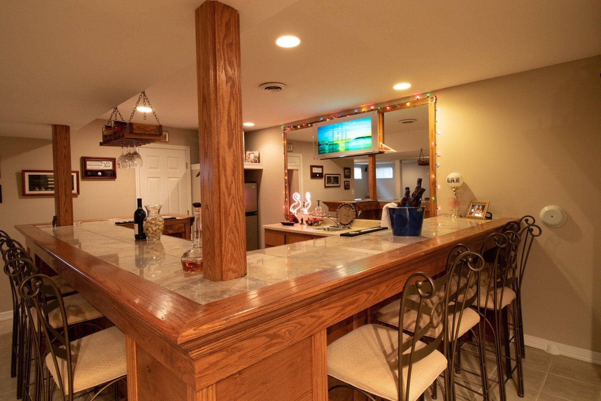 Carpenter Melrose, MA - Basement Remodeling A kitchen with a bar and chairs in it