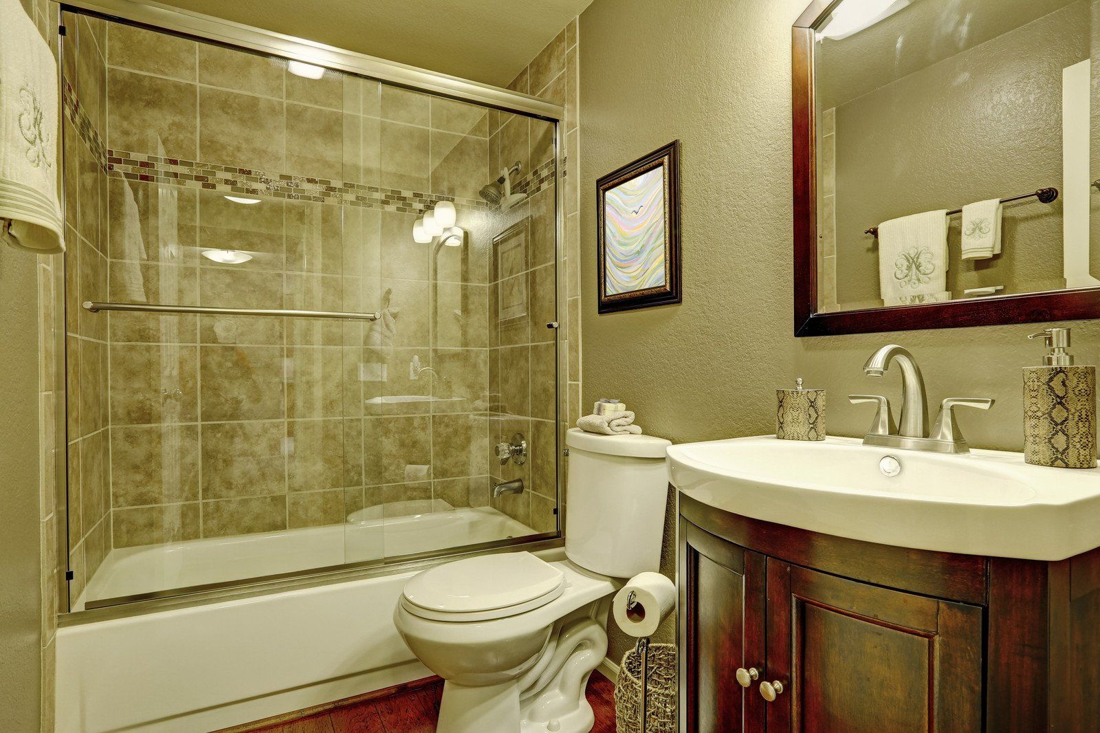 A bathroom with a toilet , sink , tub and shower.