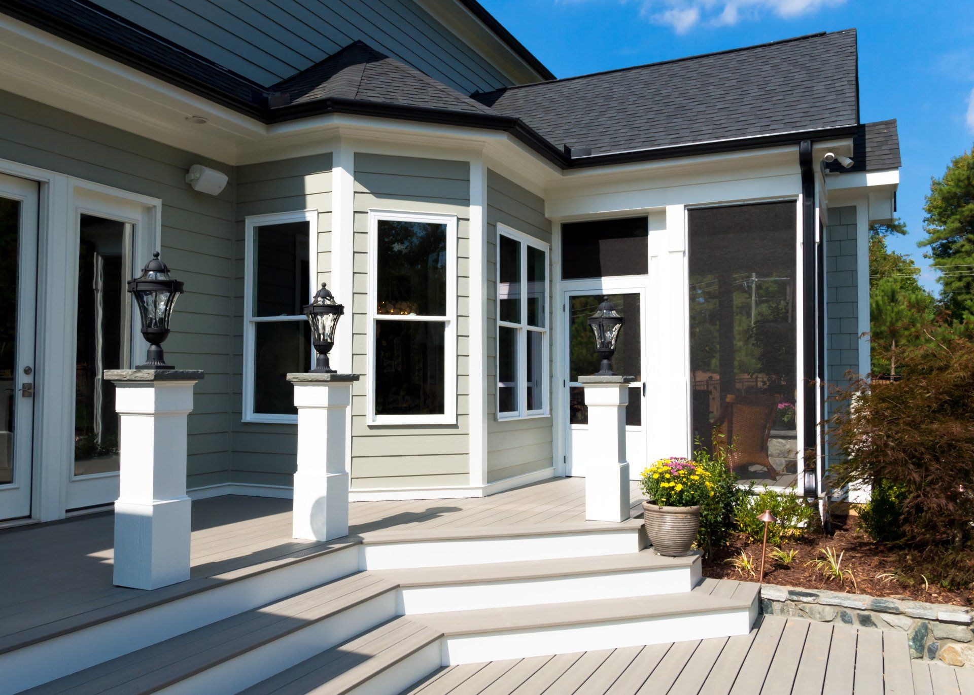 A house with a screened in porch and stairs