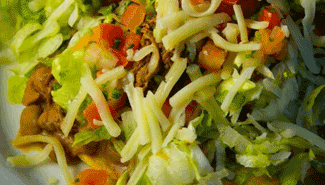 Taco salad with shredded lettuce, cheese, tomatoes, and ground meat. delivery places, Ricardo'd Place San Juan Capistrano 92675, Orange County
