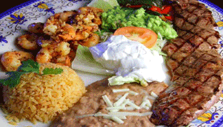 Plate of Mexican food: grilled steak, shrimp, rice, beans, guacamole, sour cream. restaurants near me that deliver, RPSJC 92675