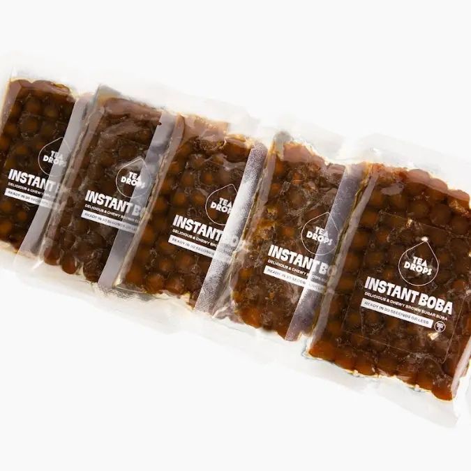 Five vacuum-sealed packs of brown sugar instant boba pearls arranged in a row against a plain white background.