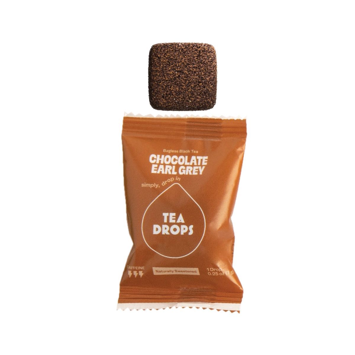 A packet of Chocolate Earl Grey Tea Drops with a single square tea drop positioned above it.