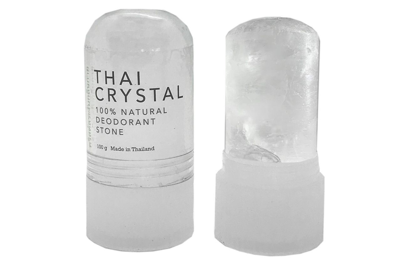 A Thai Crystal 100% natural deodorant stone standing next to its translucent, cylindrical cap.