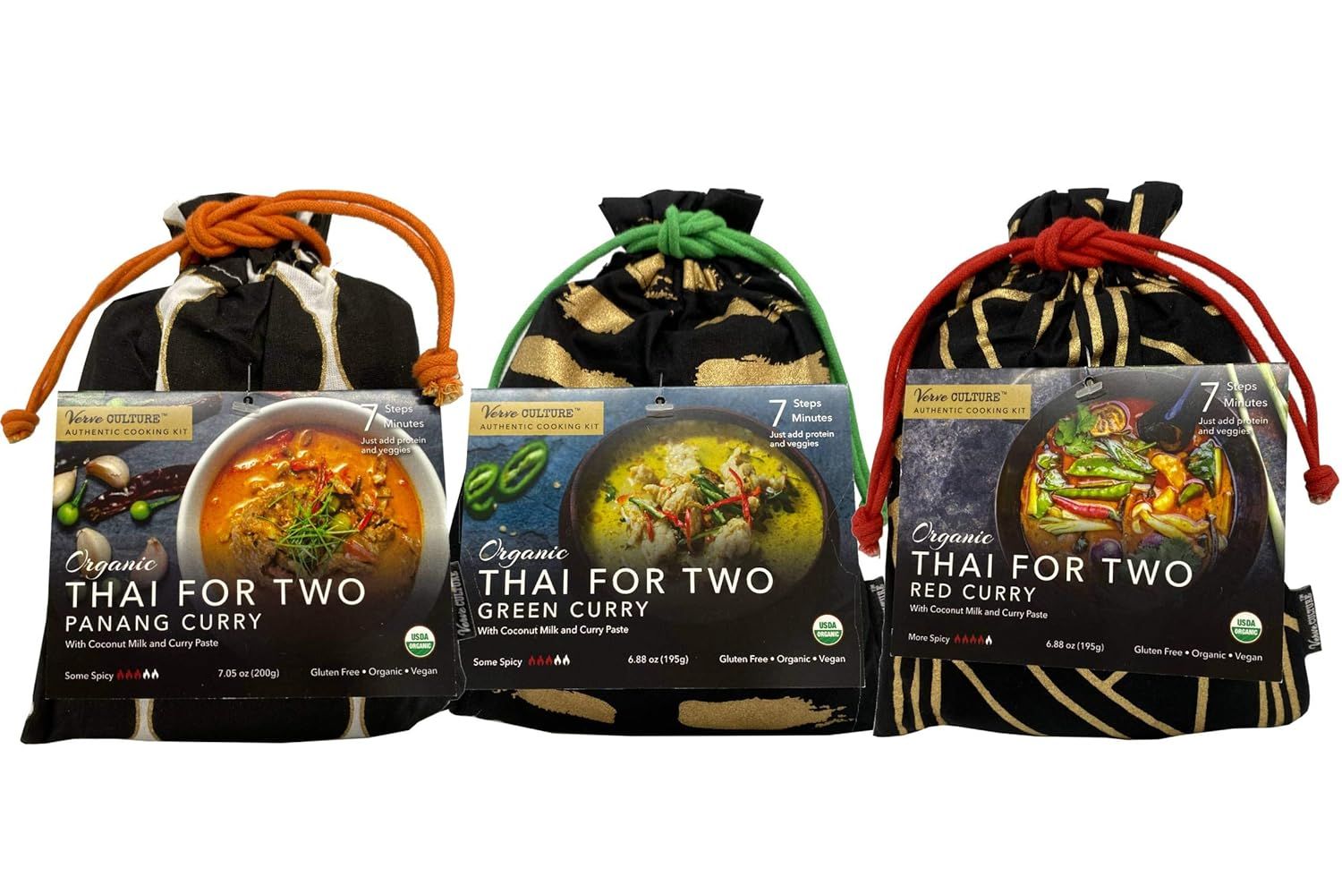 Three Thai For Two curry pouches in black fabric bags with orange, green, and red drawstring cords.