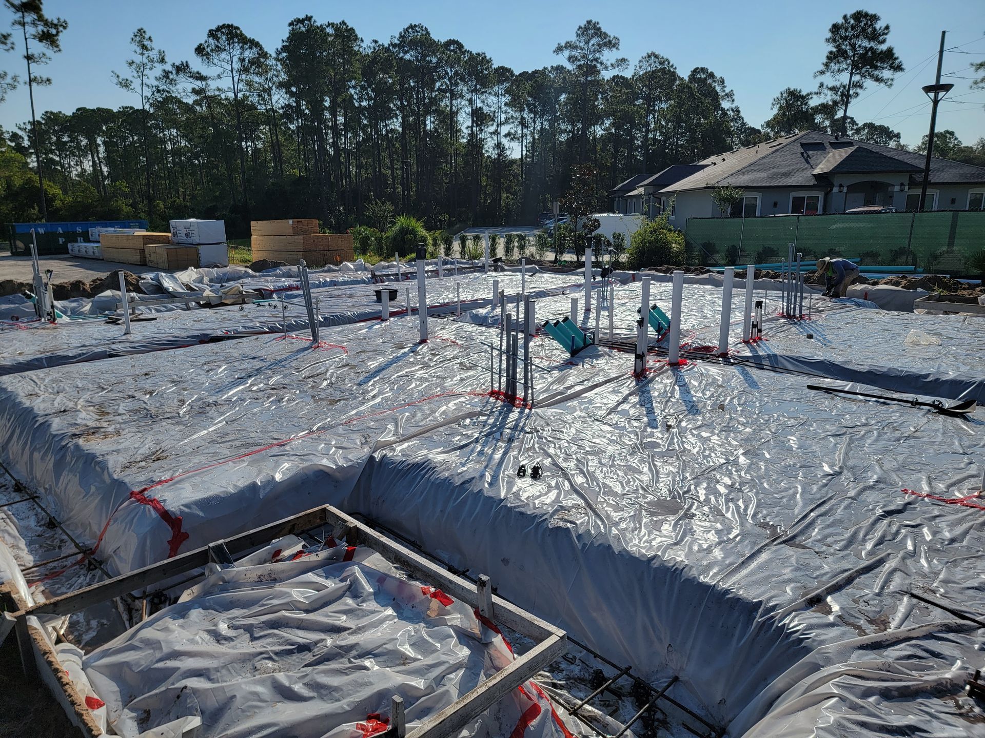 A construction site with a lot of plastic covering the ground