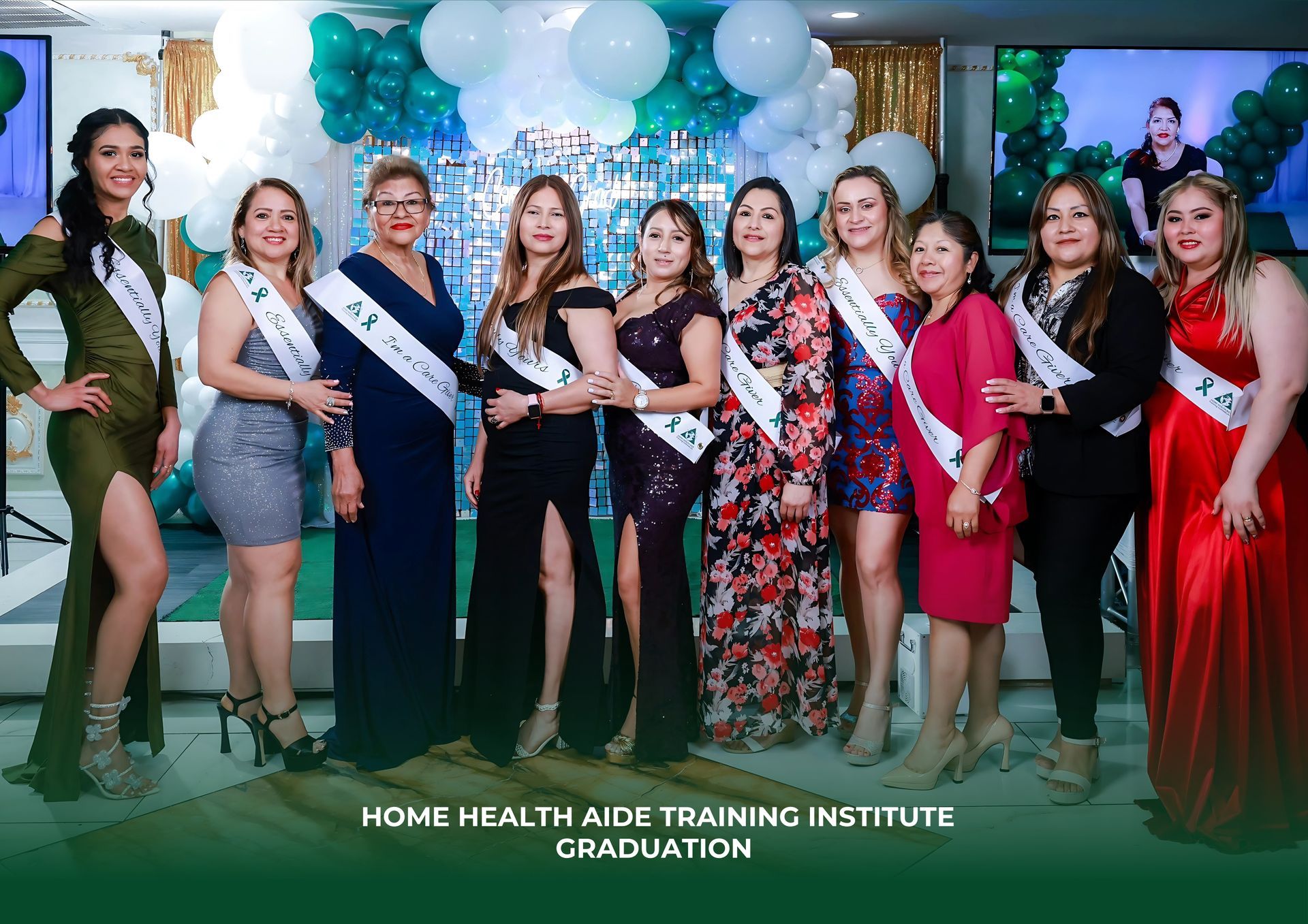 Nine graduates in formal wear and sashes stand smiling for a photo at a Home Health Aide Training Institute graduation.