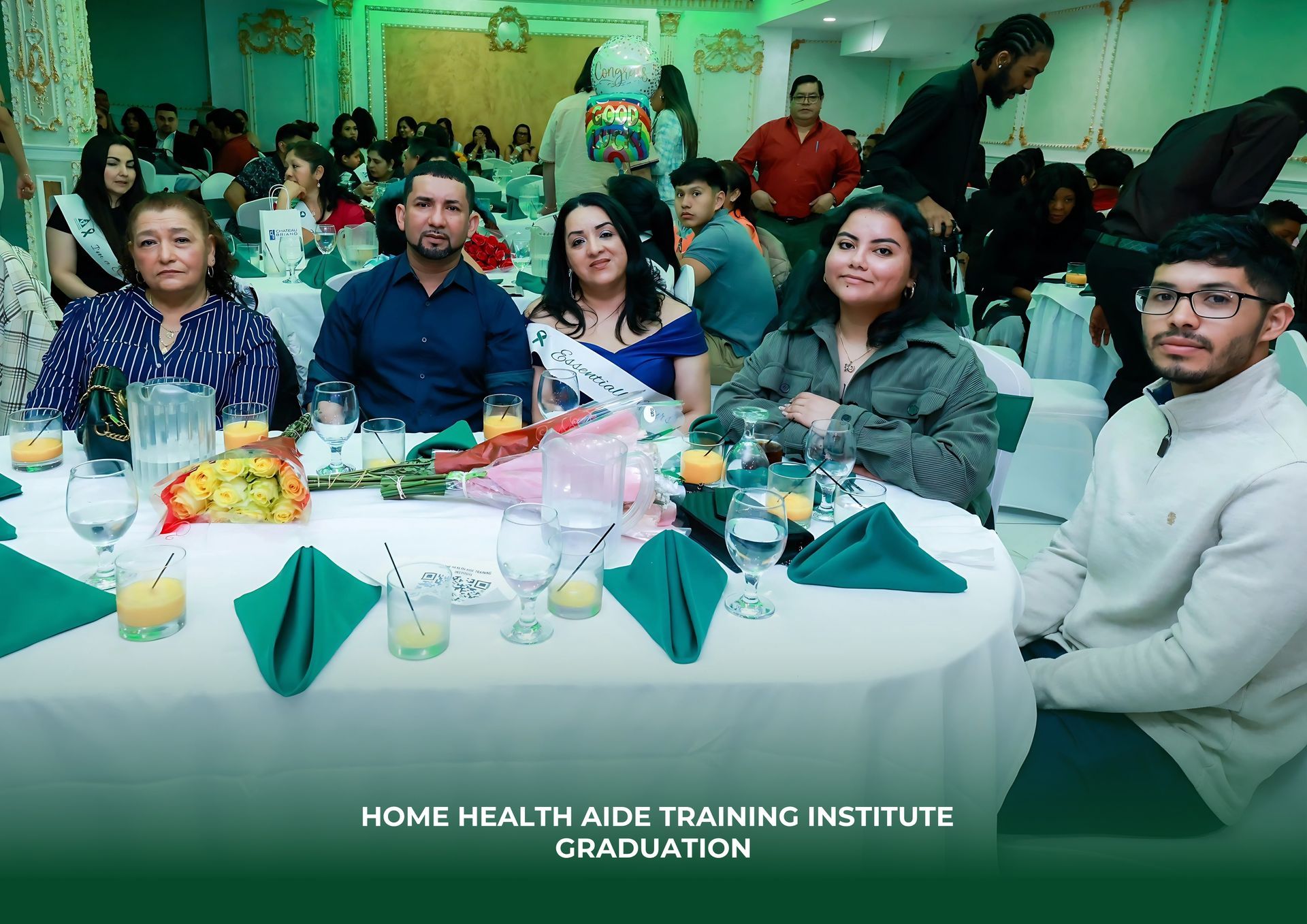 People at round tables in a banquet hall for a Home Health Aide Training Institute graduation.
