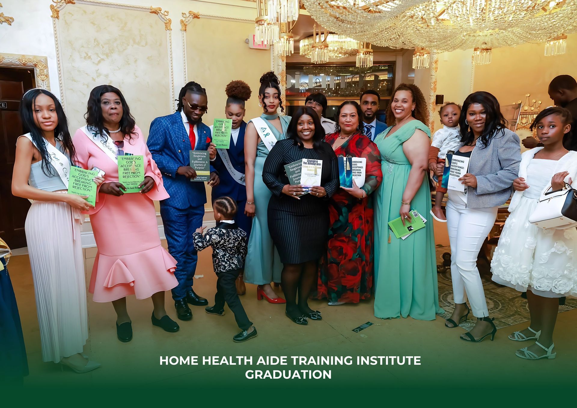 Graduates and guests stand for a group photo at a Home Health Aide Training Institute graduation in an elegant hall.