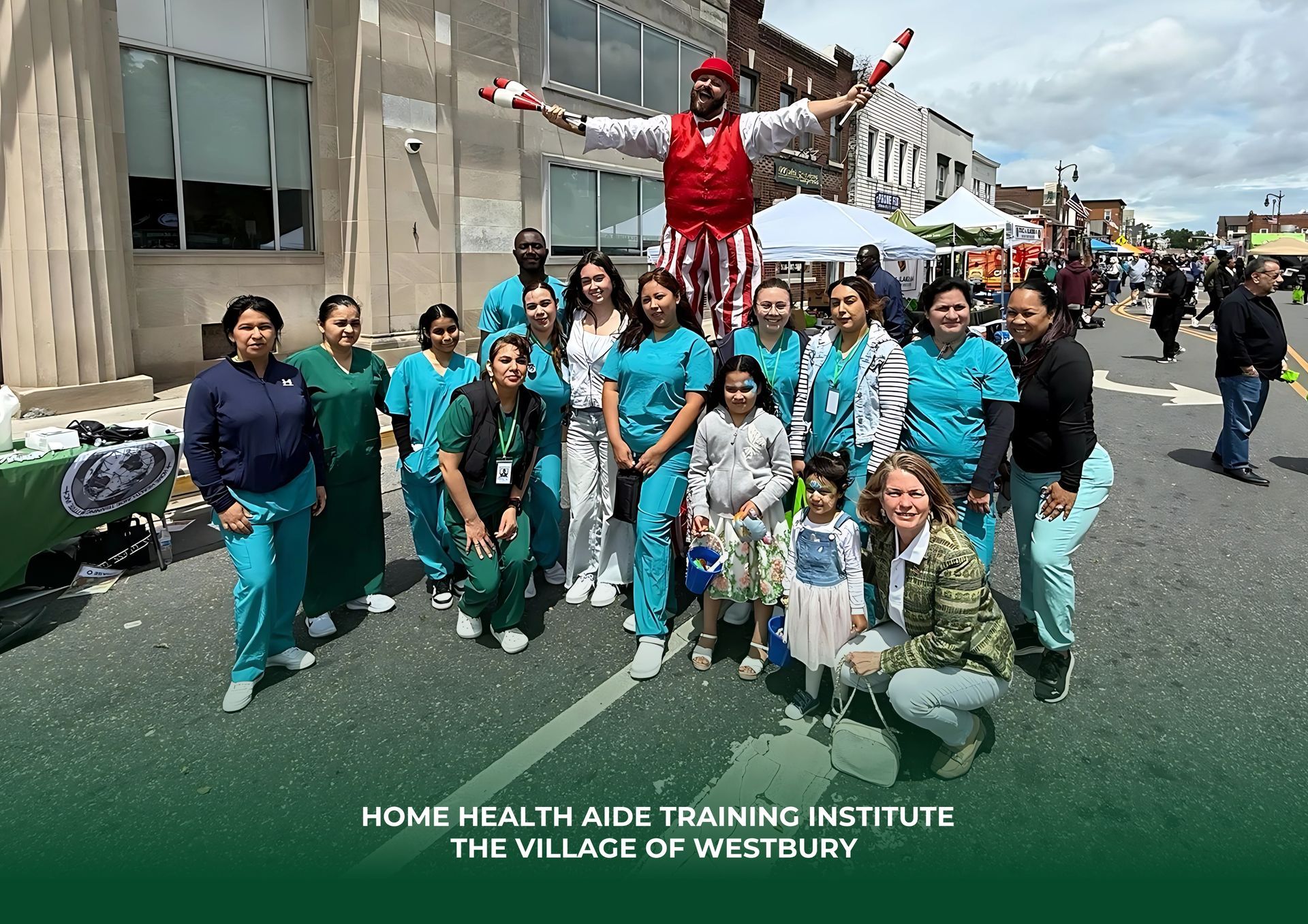 A group from the Home Health Aide Training Institute poses outdoors in Westbury with a performer in a red-and-white suit.