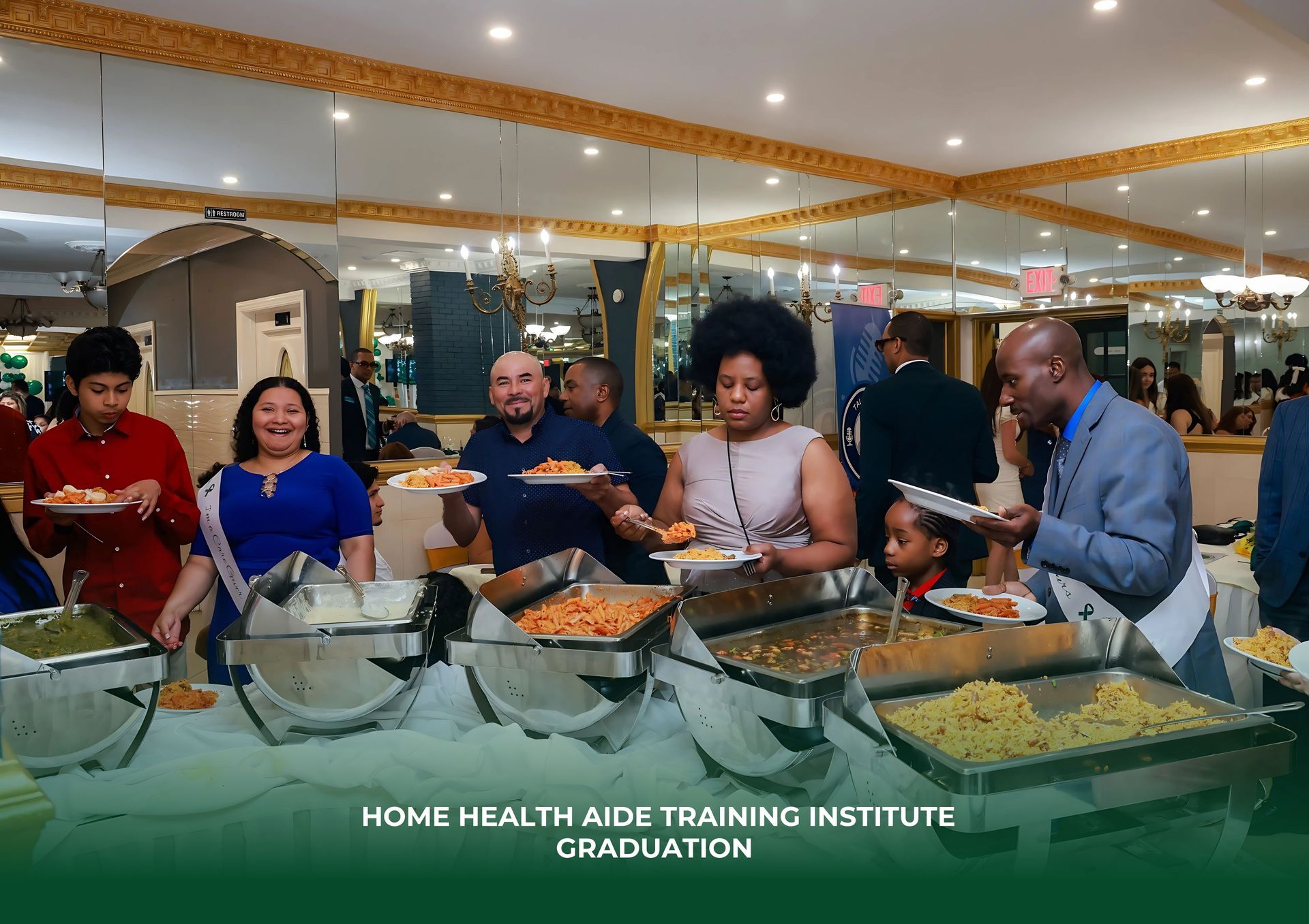 Graduates and attendees serve themselves at a buffet table during a Home Health Aide Training Institute graduation event.