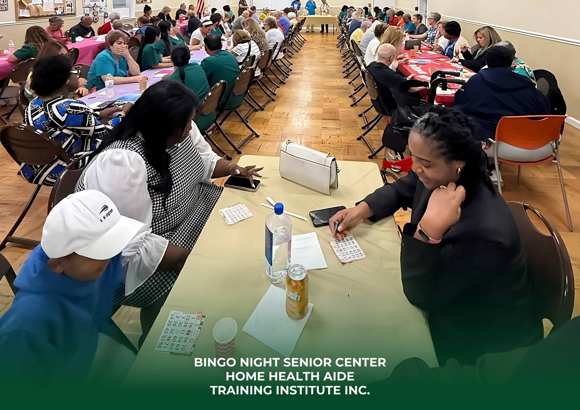 People play bingo at tables in a large hall during an event hosted by Home Health Aide Training Institute Inc.