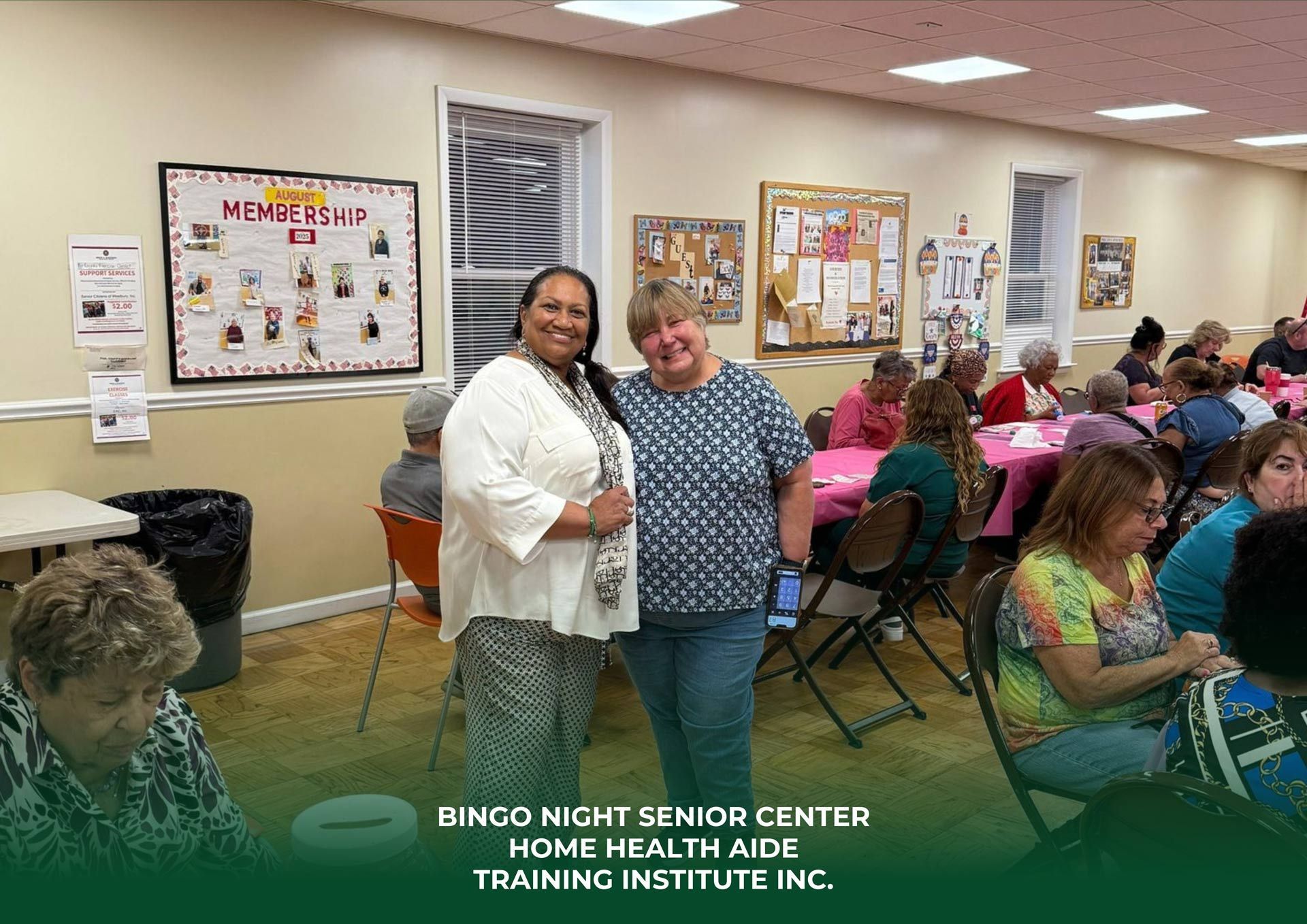 Two people stand together in a senior center during a bingo event with others seated at tables in the background.