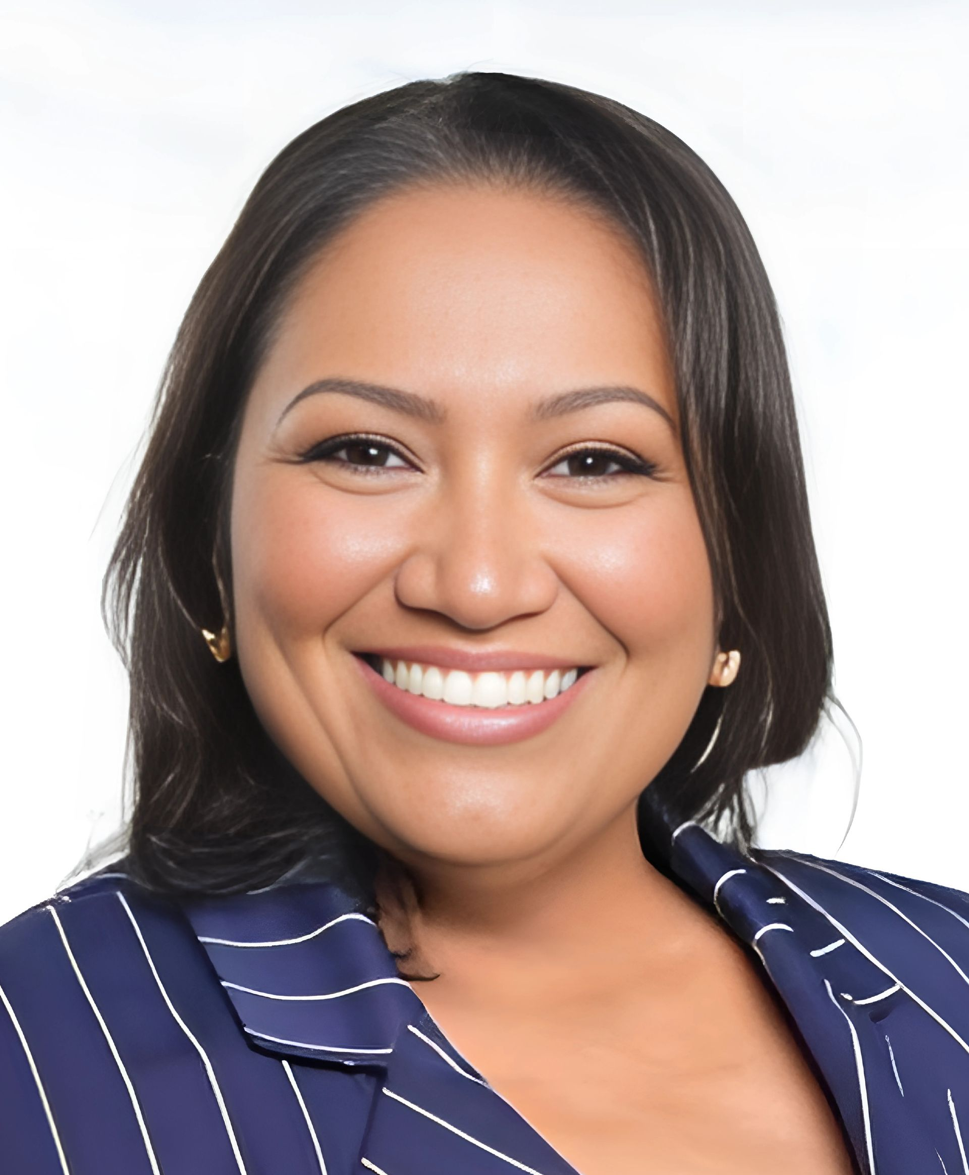 Smiling professional wearing a navy blue striped blazer against a white background.