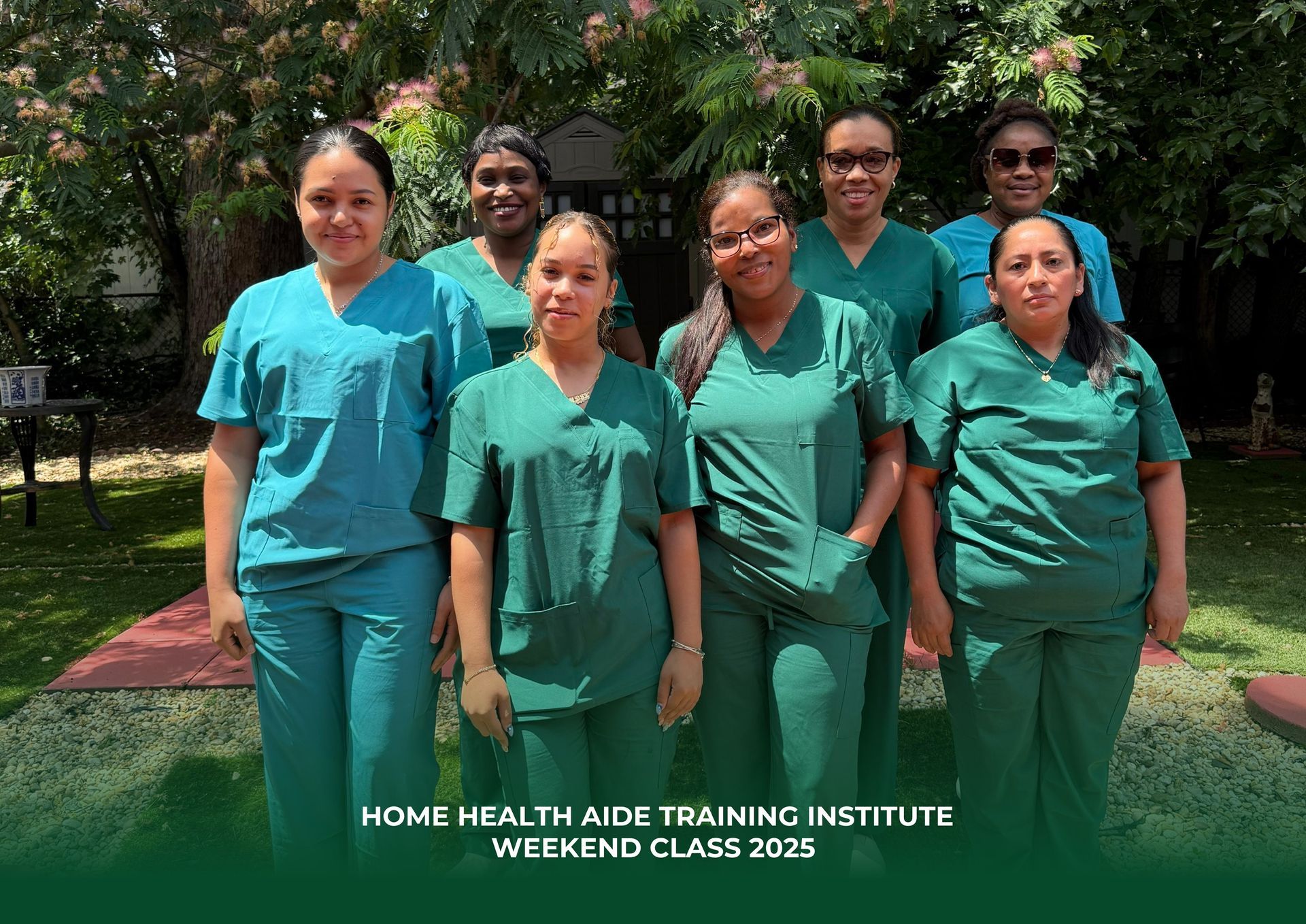 A group of six people in green medical scrubs pose outdoors for a Home Health Aide Training Institute class photo.