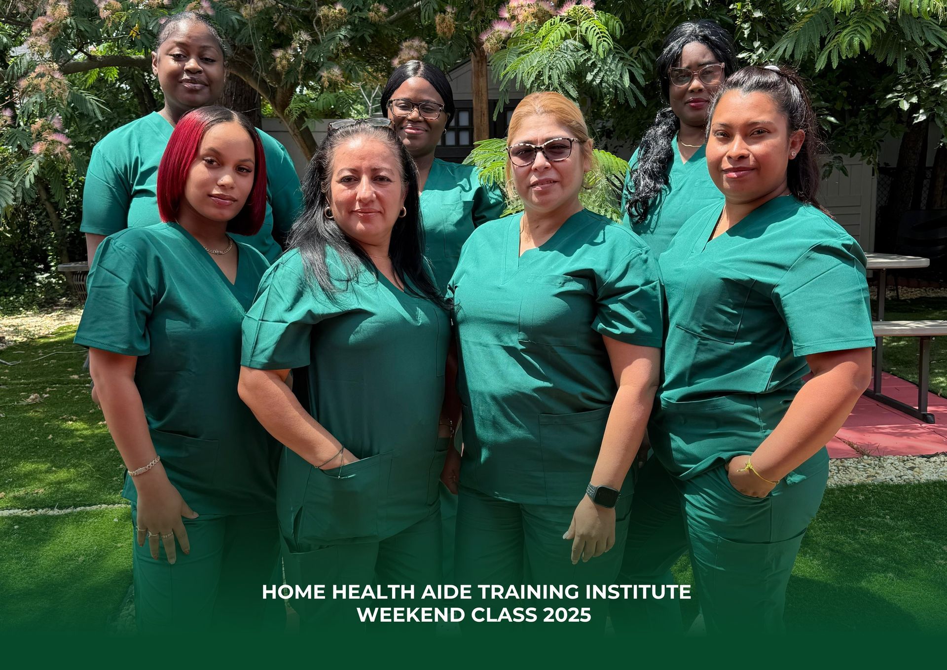 A group of seven people in green scrubs posing outdoors, with the text 