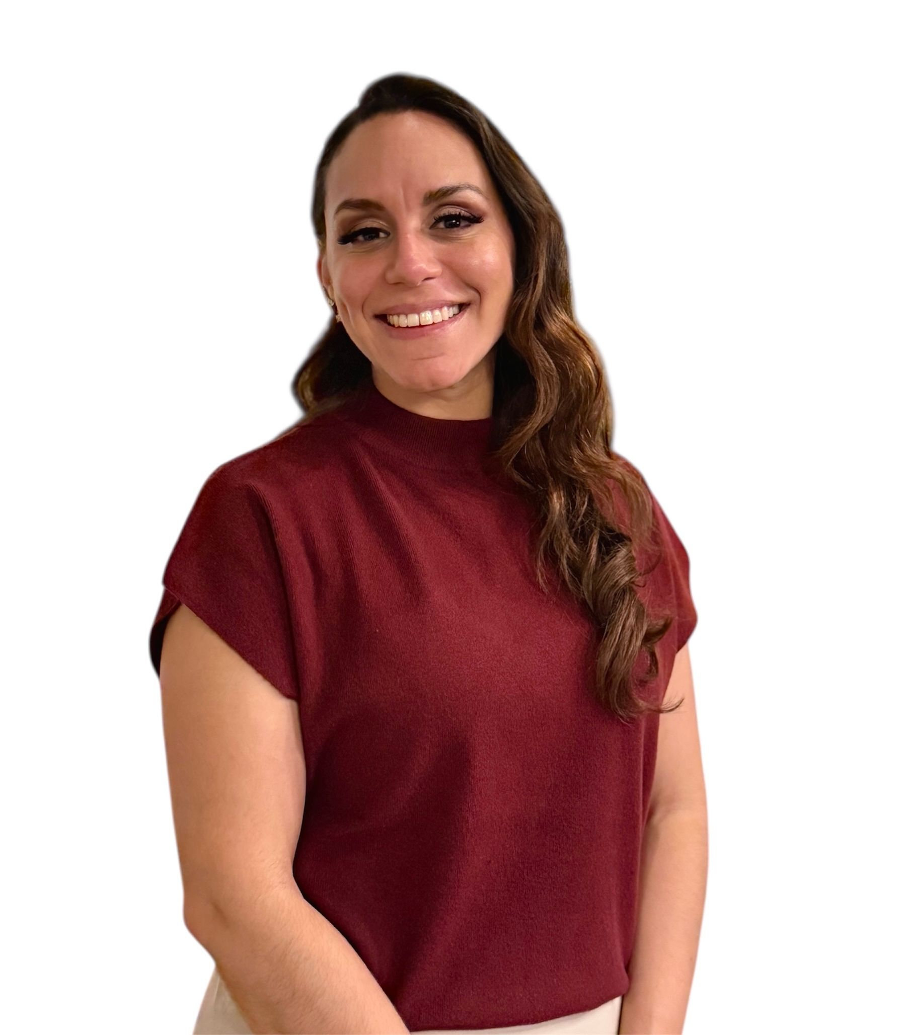 A smiling person with long brown hair wearing a maroon short-sleeved top against a white background.