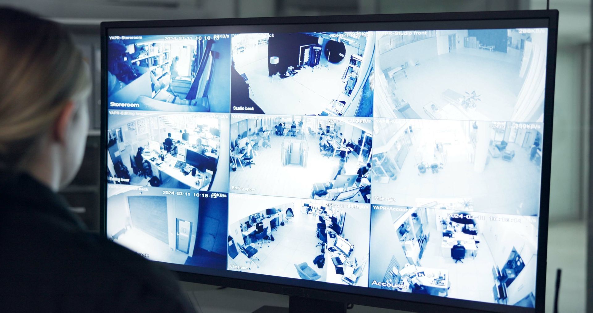 Security monitor with multiple CCTV camera feeds on a large wall screen