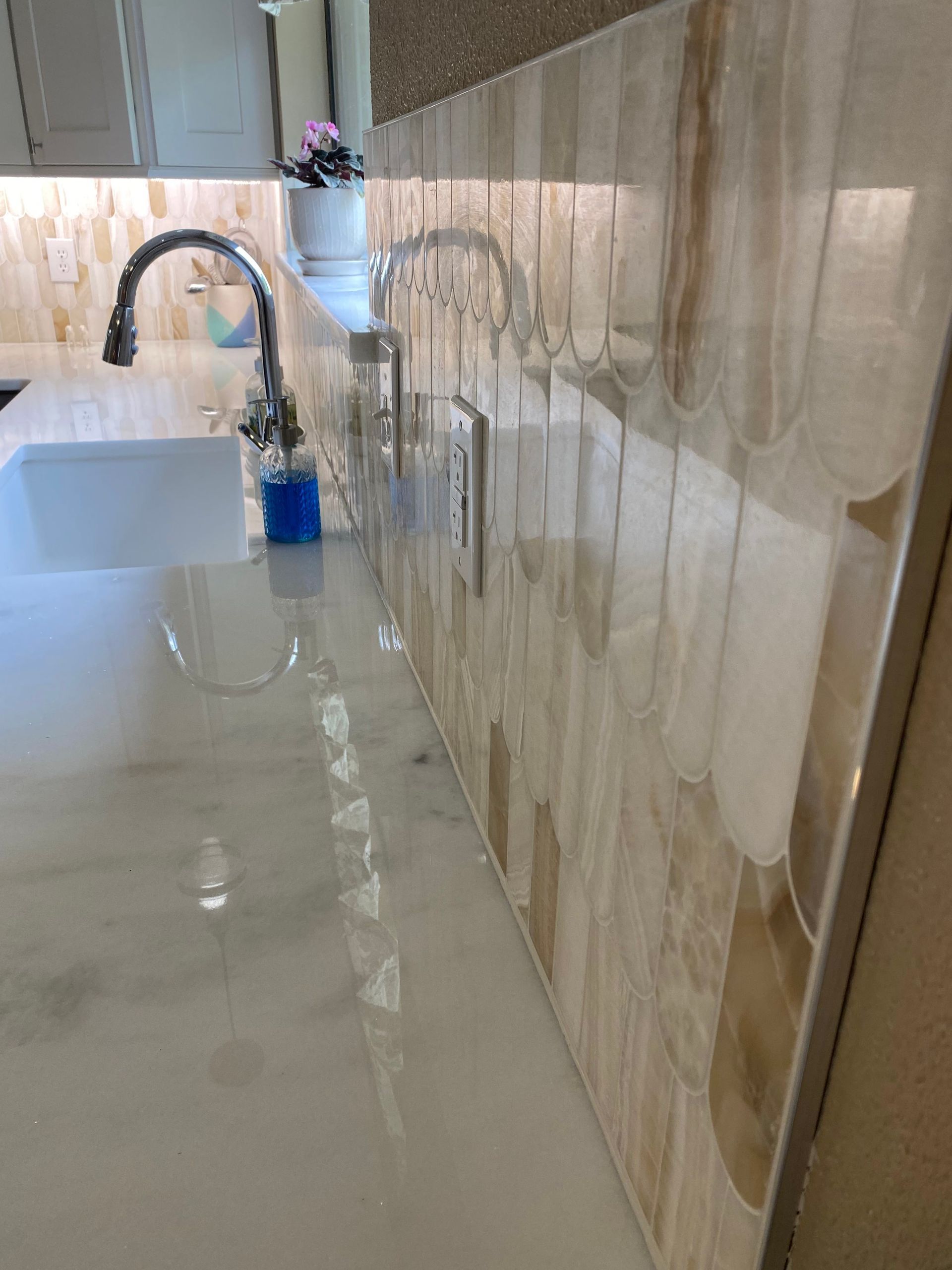 Kitchen sink countertop with water flooding across the surface and running toward the camera