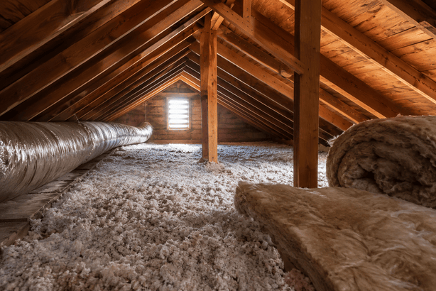 Older attic in an Altadena home with insulation and exposed roof framing needing new insulation