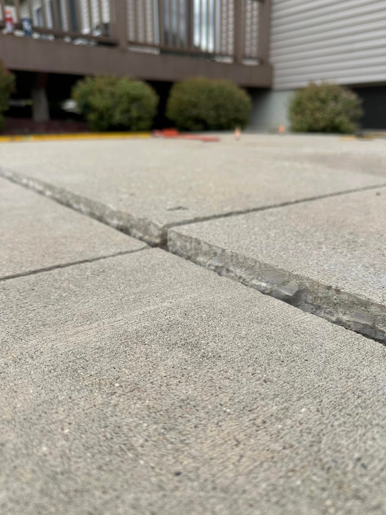 Concrete patio slabs with a large gap between them.