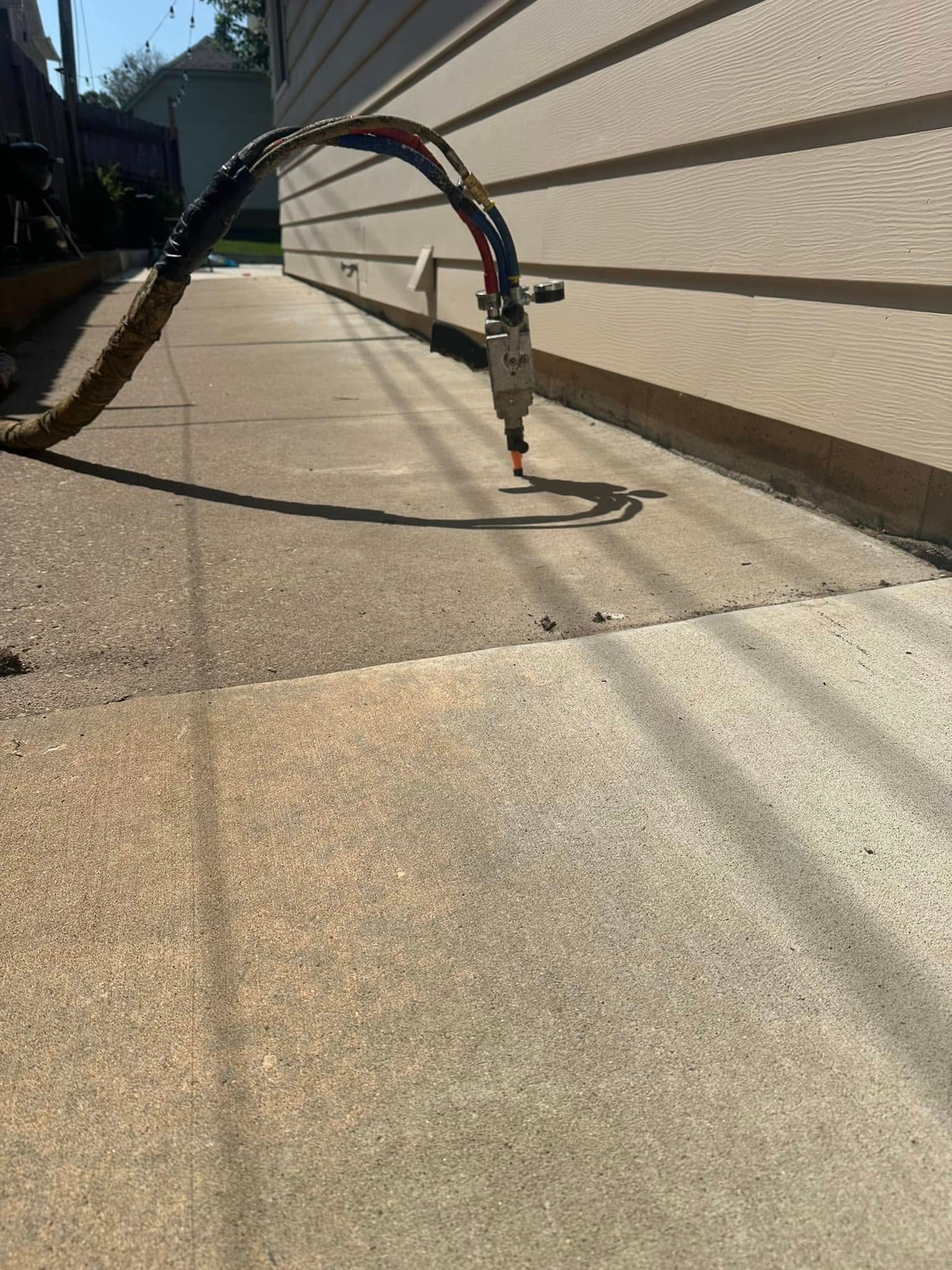 Plasma cutter on concrete slab, near a house.