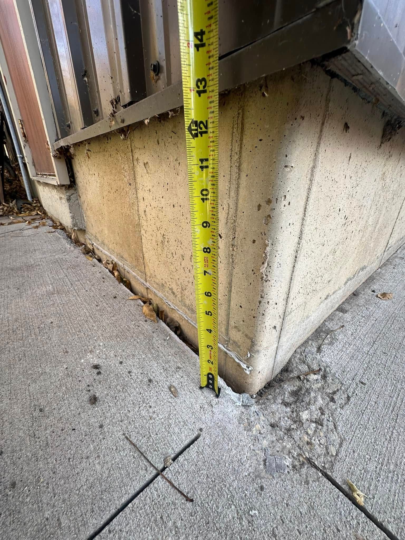 Tape measure shows a concrete step is approximately 6 inches high.
