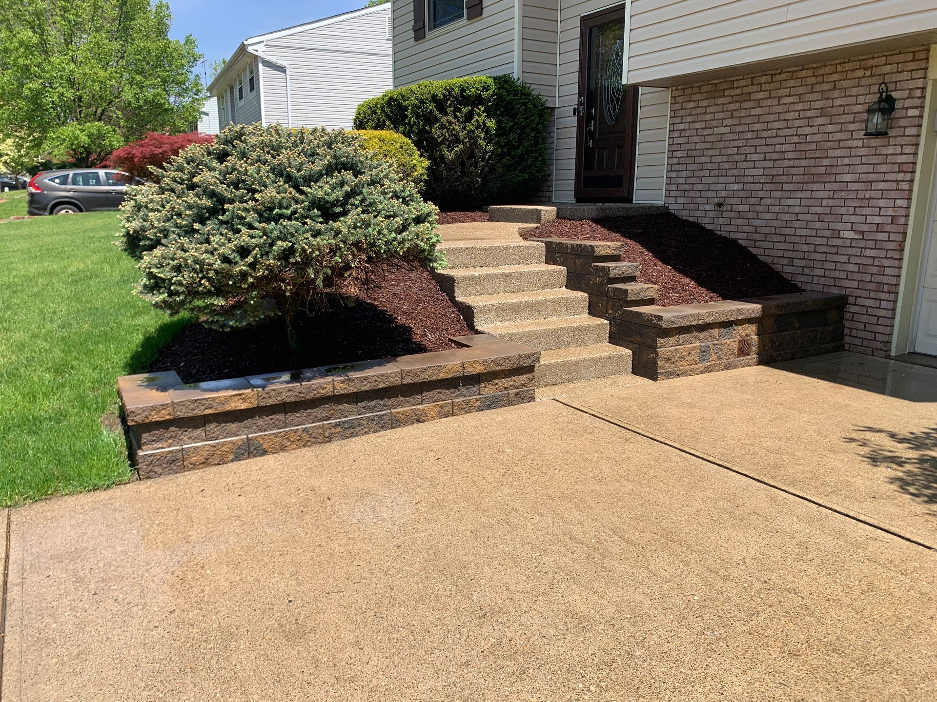 There are stairs leading up to the front of the house.