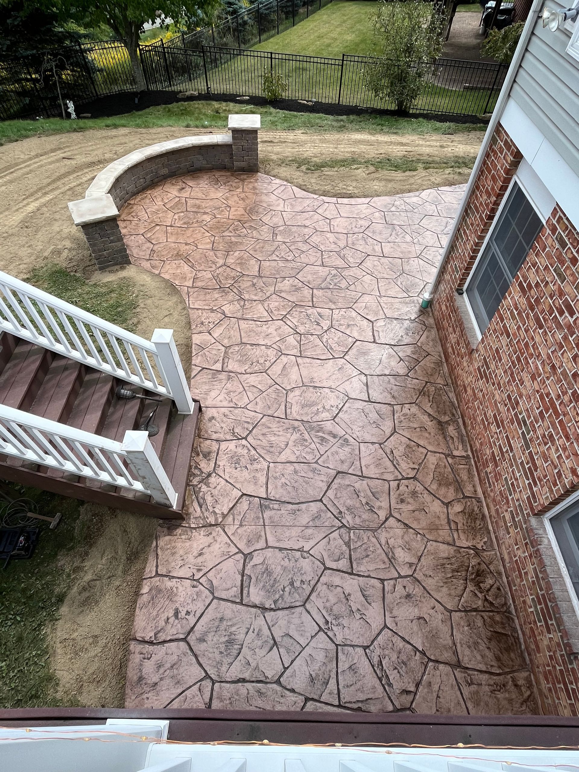 A brick house with a patio in front of it.