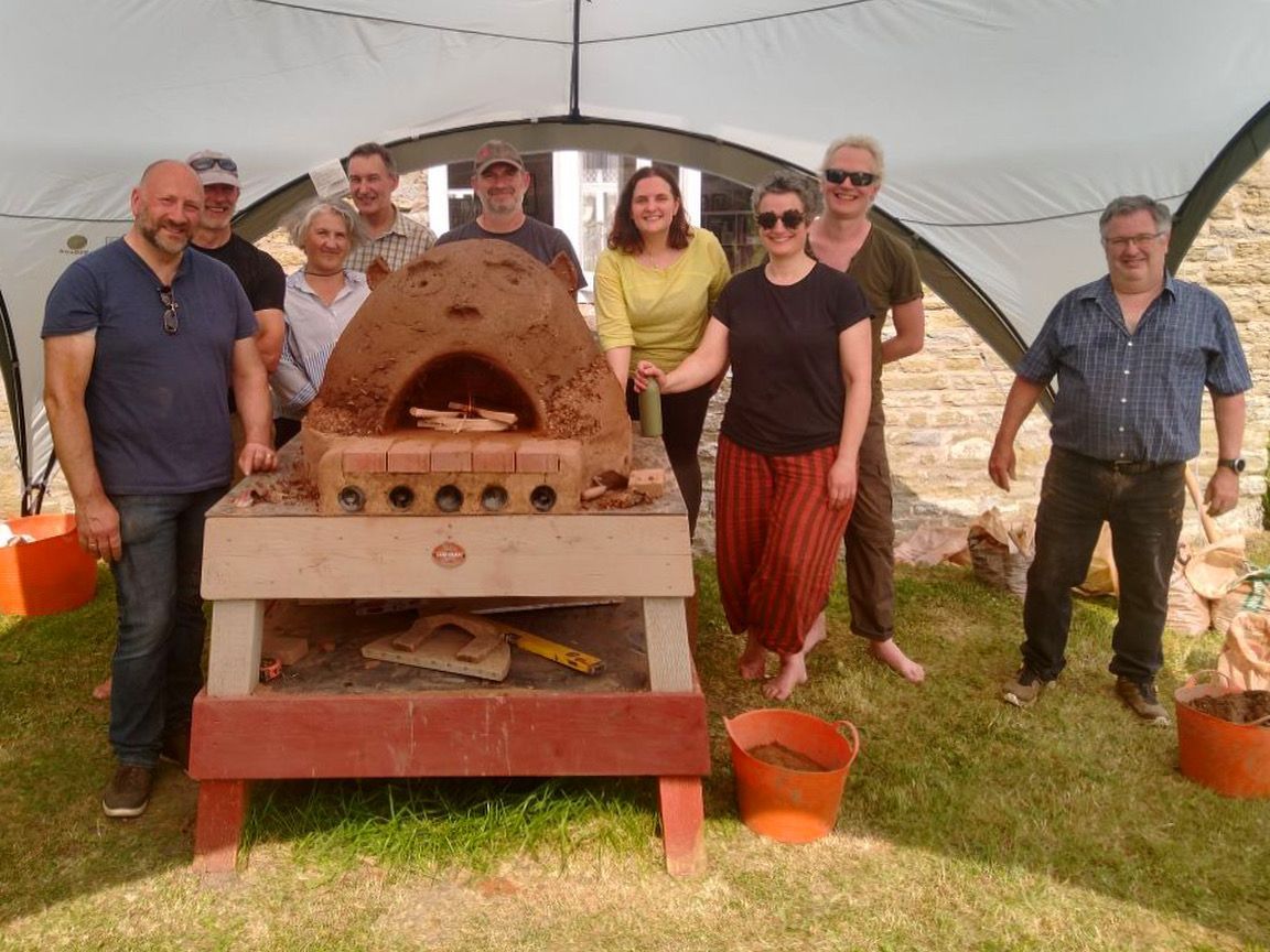 students at a one day cob oven workshop