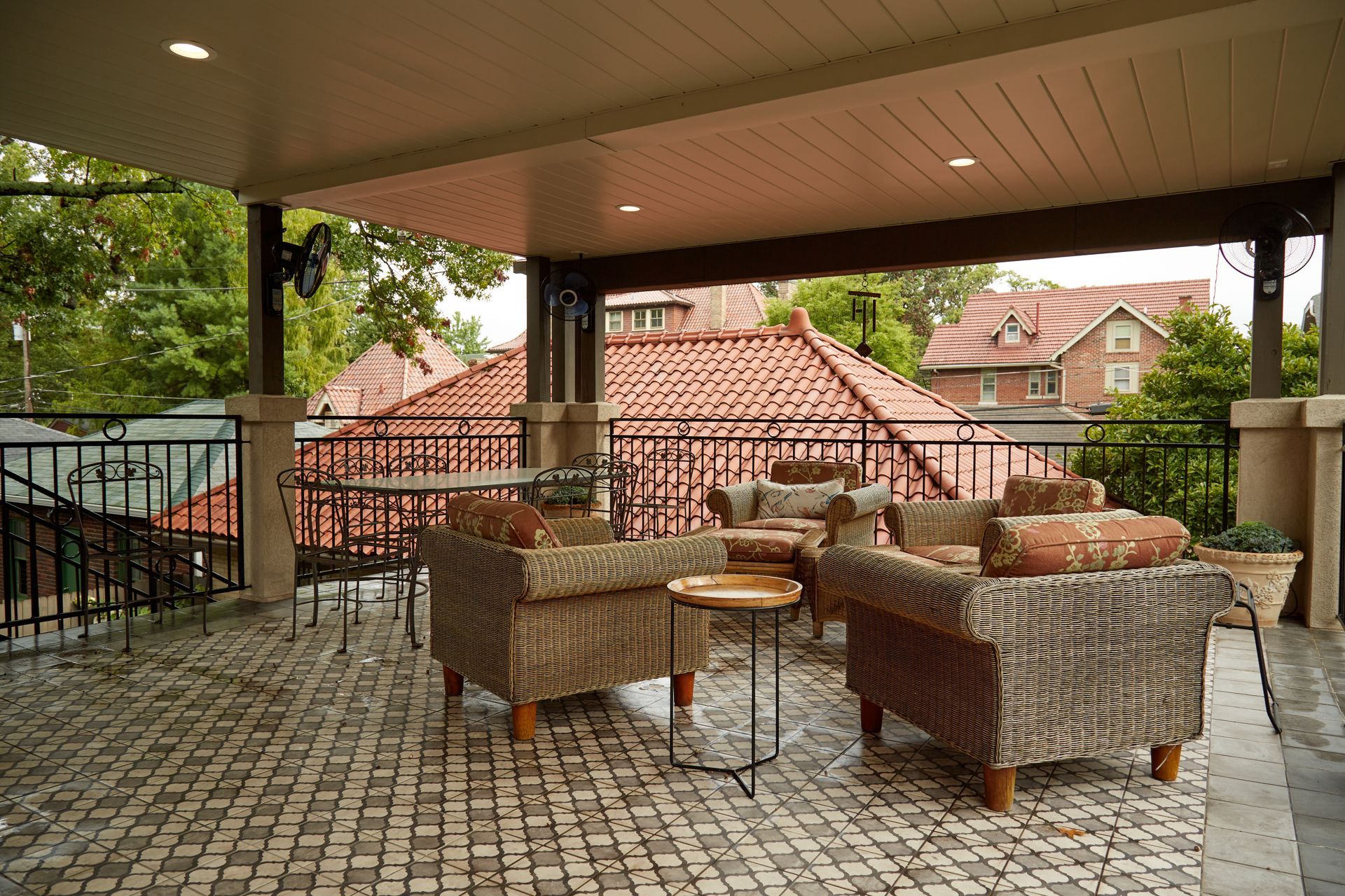 A patio with wicker furniture and a view of a house