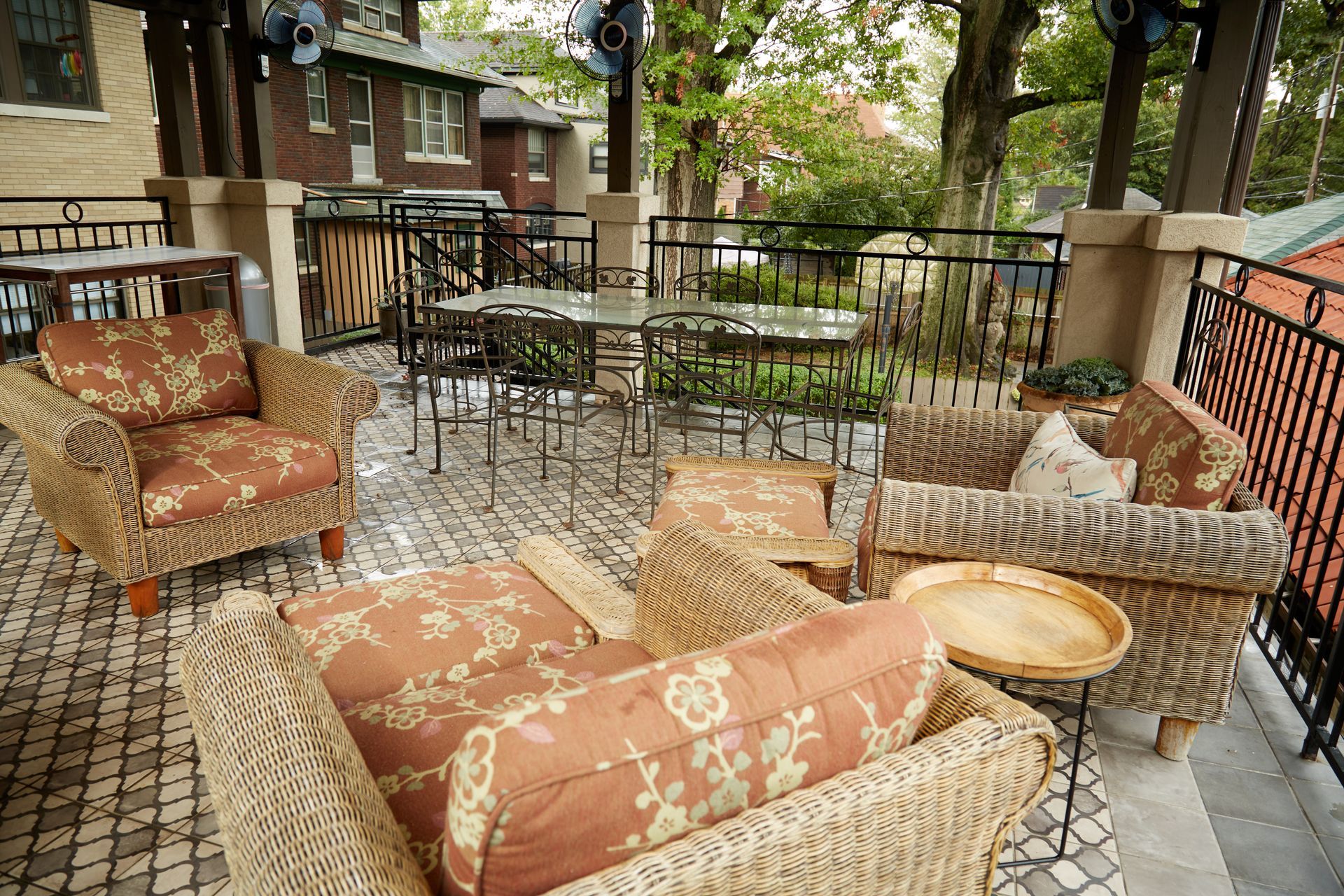A patio with wicker furniture and a table
