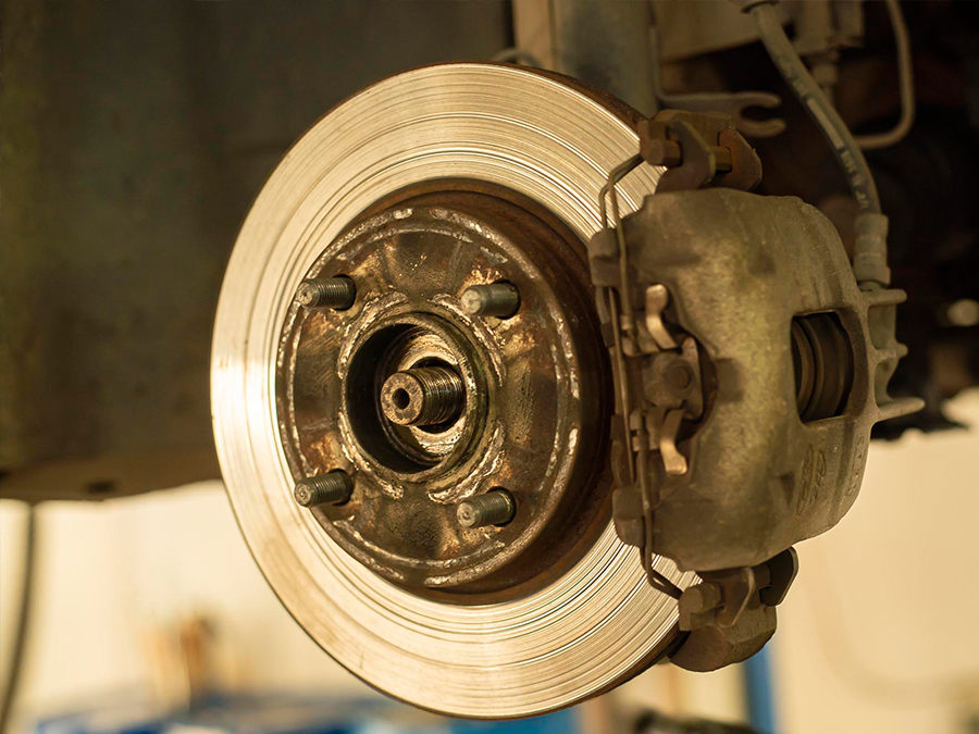 A close up of a brake disc on a car.